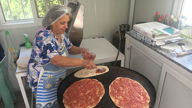 In the mountains of Lebanon, this chef makes lahm bi ajeen — a manousheh-like flatbread made with meat instead of zaatar — on a saj. // © 2017 Giselle Abcarian