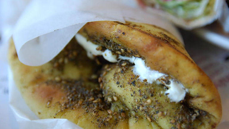 Manousheh is filled with zaatar and often a spoonful of labneh, which is similar to Greek yogurt. // © 2017 Creative Commons User avlxyz