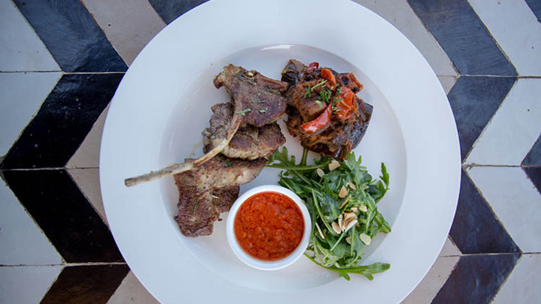 Nomad serves modern Moroccan fare, ranging from lamb chops served with spiced tomatoes, ratatouille and harissa (pictured) to more traditional tagines and mezze plates. // © 2018 Nomad