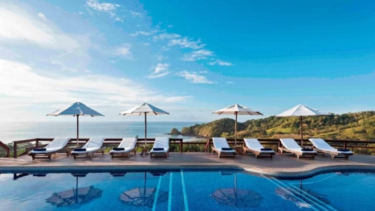 The adults-only infinity pool offers panoramic views of the coastline.