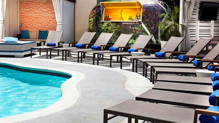 The outdoor pool area features Wet, the hotel’s signature poolside bar. // © 2016 W Hotels